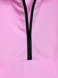 Detailed macro view of a pink windproof jacket featuring a high-quality black half-zip