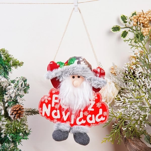 Detail of plush Santa Claus ornament with Feliz Navidad text and festive decor background