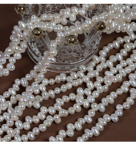 Detailed macro shot of 5-8mm irregular natural freshwater pearls on a crown glass holder