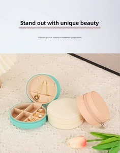 Detail view of round PU leather jewelry box with necklace hooks and ring slots