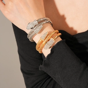 Close-up of snake wrap bracelet with diamond-encrusted head and textured scales
