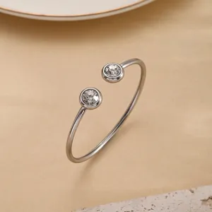 Detail view of silver evil eye bangle with sparkling cubic zirconia on stone background