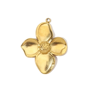 Macro view of a gold-plated stainless steel four-leaf flower pendant with textured center