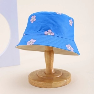 Detailed view of kids bucket hat in electric blue with purple flower smile prints