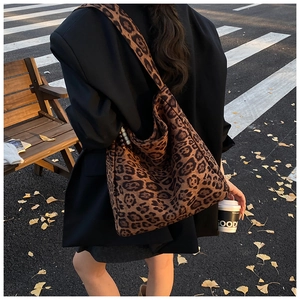Close-up of a large leopard print tote bag in brown fabric during a street photo session