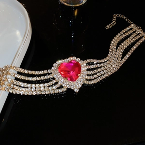Close-up of sparkling five-row rhinestone choker featuring a large red heart gemstone