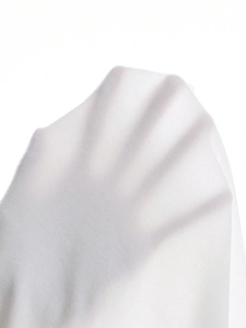 Close-up of white semi-transparent knit fabric showing texture and elasticity