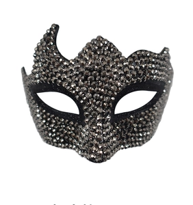 Detailed macro view of mysterious black masquerade mask featuring sparkling rhinestones