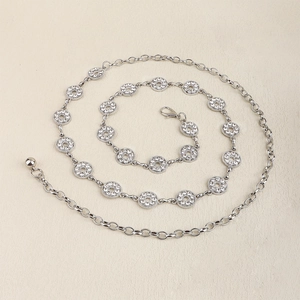 Detail of silver rhinestone waist chain belt with lobster clasp and round ball pendant