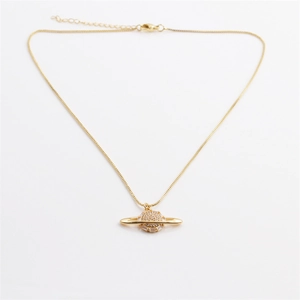 Detail of gold Saturn pendant necklace featuring sparkling zircon pave on box chain