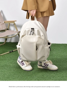 White minimalist nylon backpack featuring a large front vertical zip pocket and dual zipper