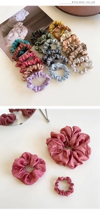Detailed view of various sizes and shimmering metallic colors of shiny scrunchie hair ties