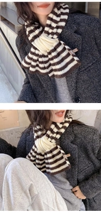 Detail view of striped wool blend knit scarf featuring a cross buckle design for women