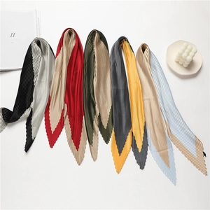 Detailed flat lay of pleated color-block scarves in various elegant combinations