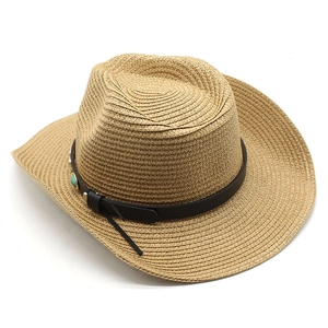Detail of straw cowboy hat with leather band, turquoise beads and metallic rivets