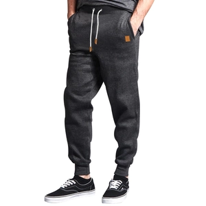 Detail of dark grey joggers featuring elastic waist and contrasting white drawstrings