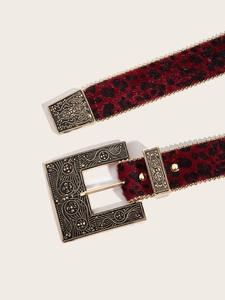 Détail de la ceinture léopard rouge avec perles dorées et boucle baroque gravée