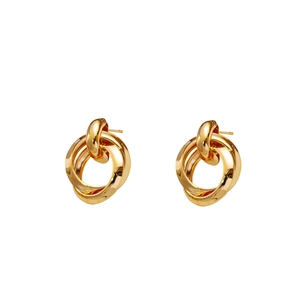 Detailed macro view of triple interlocking gold rings stud earrings with polished finish