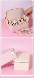 Macro detail of portable pink and beige PU leather travel jewelry box with multiple layers