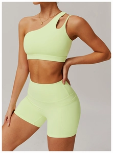 Detail of light green asymmetrical single shoulder yoga bra with high elastic matte fabric