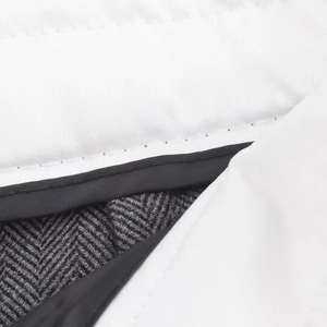 Macro detail of white lining and grey herringbone fabric with precision stitching