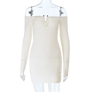 Detailed view of white off-shoulder mini dress with ripple texture and metal accents