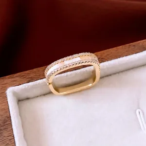 14K gold plated rectangle ring with white inlay and zircons in a velvet jewelry box