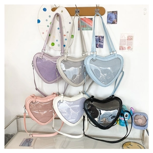 Detailed view of heart-shaped Ita bags in multiple colors featuring clear PVC window