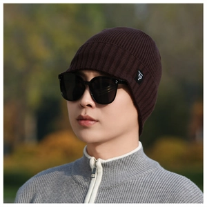 Close-up of dark coffee knit beanie with fine texture and black rectangular brand label