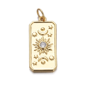 Detailed close-up of a gold rectangle pendant featuring sun moon and star motifs