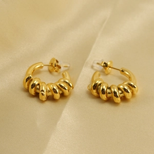 Elegant 18K gold plated stainless steel twisted rope C-shaped hoop earrings on silk
