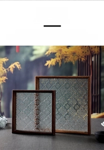 Close-up of retro Begonia pattern embossed glass and dark wood frame tray set