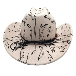 Detail of western cowboy hat featuring bird print patterns and beaded chin strap accent