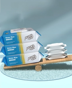 Three packs of extra thick kitchen wipes with 80 pieces per pack on wooden background