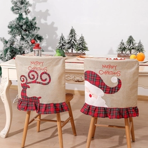 Christmas chair covers featuring Santa and reindeer designs with red plaid ruffles