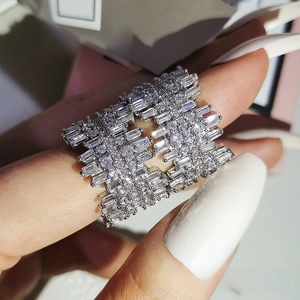 Close-up of luxury wide pave ring with square zircons and silver plating on finger
