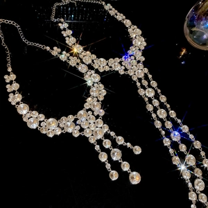 Macro shot of luxurious sparkling crystal tassel necklaces with multilayered silver chains