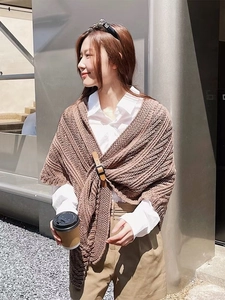 Detail of coffee brown knitted shawl with premium dark brown leather buckle closure