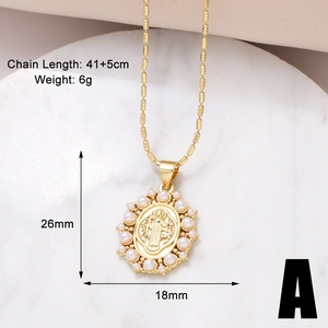 Detailed specs of a gold heart pendant necklace with pearls and icons on marble