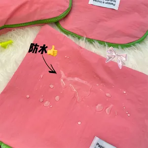 Pink waterproof travel organizer showing high-density hydrophobic coating and zip closure