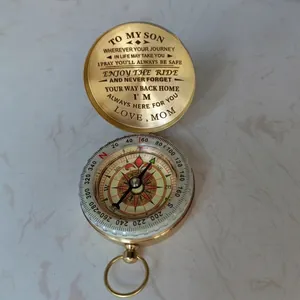 Close-up of vintage brass compass with engraved sentimental message for son