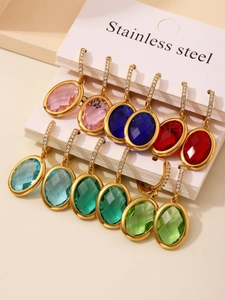 Detailed close-up of oval crystal drop earrings in multiple colors with gold stainless steel