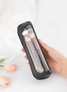 Portable black leather makeup brush bag with clear window held in hand for travel