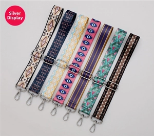 Detail view of seven ethnic pattern handbag straps with silver metal adjustment buckles