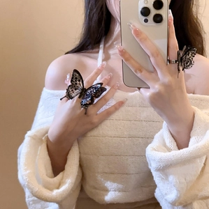 Vintage acrylic layered butterfly open ring shown on hand in a stylish mirror selfie