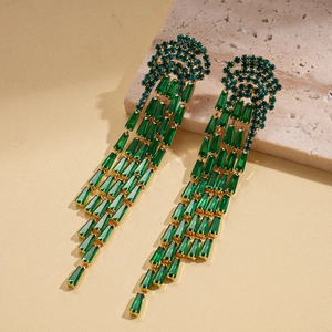 Detail of emerald green zircon jellyfish tassel earrings with long gold fringe chains