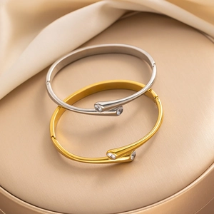 Minimalist gold and silver titanium steel bangles with cubic zirconia in a stacked view
