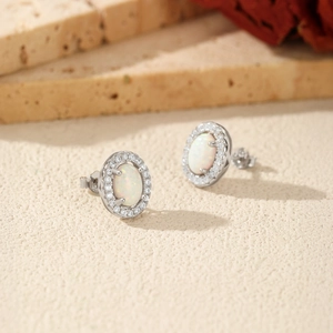 S925 sterling silver opal stud earrings with zircon halo on neutral stone background