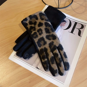 Detail of leopard print plush warm gloves on a magazine for a stylish winter look
