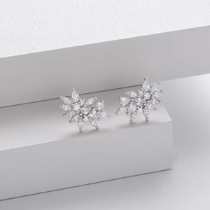 Detail view of silver snowflake earrings with sparkling marquise and round zircon stones